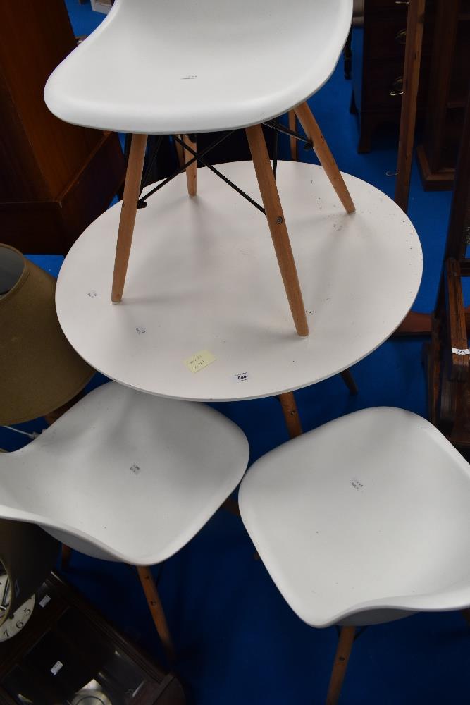 A modern small circular dining table and three similar chairs, in white , diameter approx 80cm