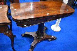 A 19th Century rosewood fold oover card table in William IV style with column support and platform