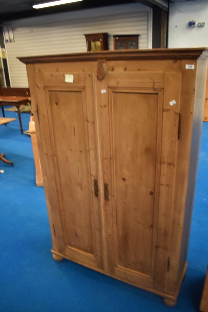 A Victorian stripped pine cupboard having shelved interior, dimensions approx W106 D38 H156cm