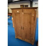 A Victorian stripped pine cupboard having shelved interior, dimensions approx W106 D38 H156cm