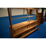 A 19th Century pine dresser having open delft rack , recess to lower section flanked by cupboards