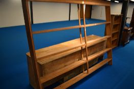 A 19th Century pine dresser having open delft rack , recess to lower section flanked by cupboards