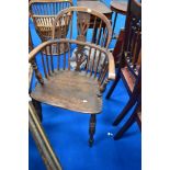 A traditional Windsor armchair having low back