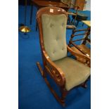 A Victorian mahogany rocking chair having later dralon upholstery