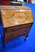 A mid 20th Century walnut bureau , having ball and claw feet, width approx 74cm