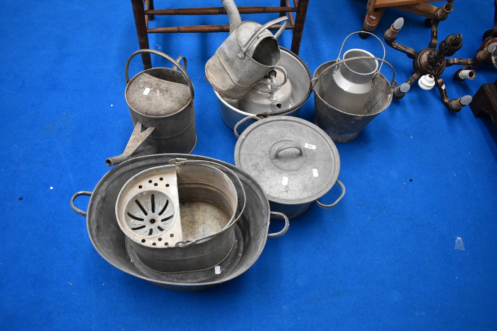A selection of vintage watering cans, tea can , jam pan etc