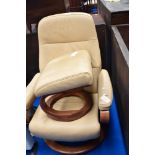 A modern Stressless style chair and footstool in cream/mustard