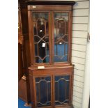 An Edwardian mahogany full height corner display having astral glazing to top and bottom sections