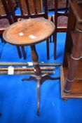 A 19th Century oak wine table having rimmed circular top on turned column and triple splay legs,