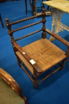 A 19th Century framed armchair having partially bobbin turned frame and strung seat