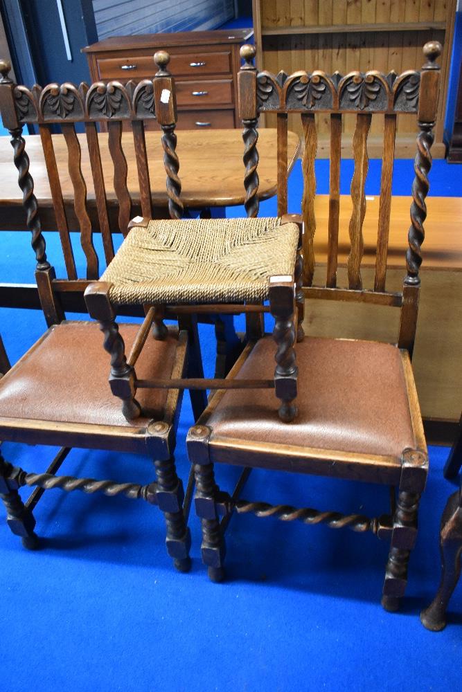 A pair of early 20th Century oak wave and rail back dining chairs having barley twist frames , and a