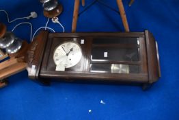 An early 20th Century oak cased wall clock having silvered dial