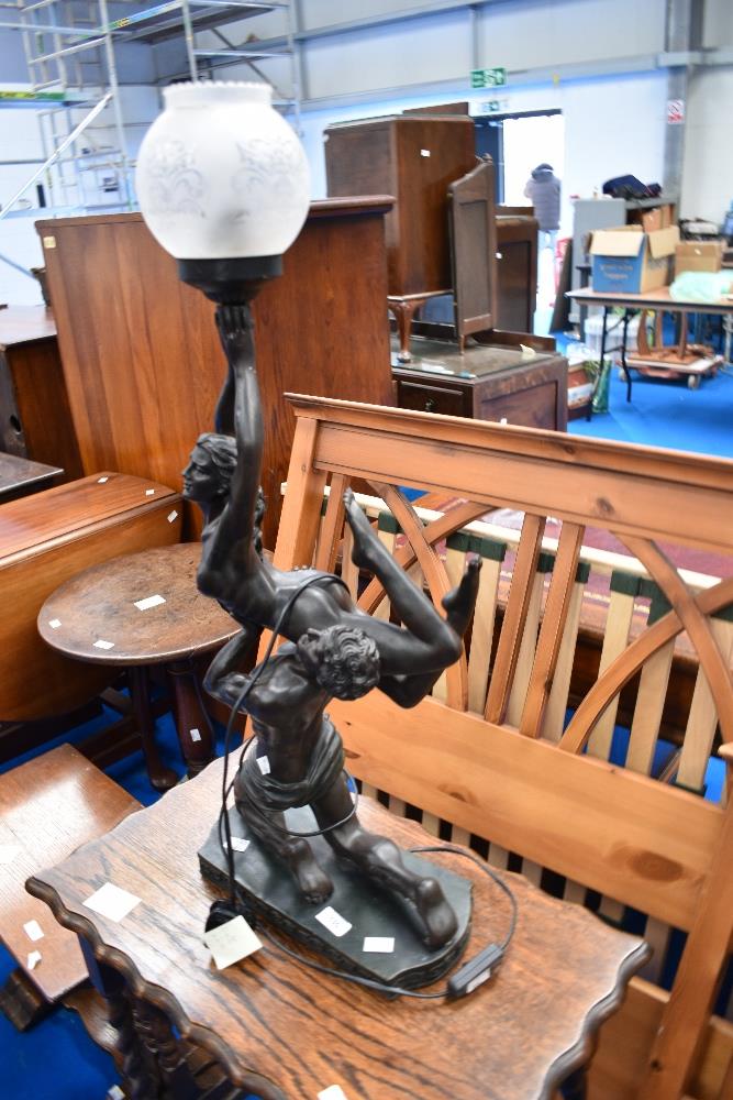 A reproduction bronze effect table lamp, modelled as exotic dancers