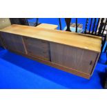A vintage teak base unit/sideboard having central drawers and sliding doors, width approx. 210cm