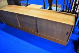 A vintage teak base unit/sideboard having central drawers and sliding doors, width approx. 210cm