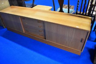 A vintage teak base unit/sideboard having central drawers and sliding doors, width approx. 210cm