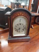 An Edwardian mahogany cased mantel clock having silvered dial , labelled to interior HAC