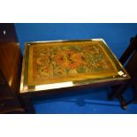 A vintage coffee table having deity decoration, approx 89 x 62cm