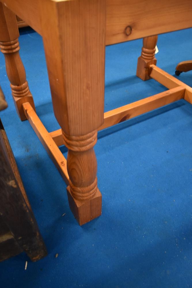 A traditional pine dining table having turned frame, approx 164 x 92cm