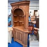 A stripped pine corner shelf with cupboard under , height approx. 200cm