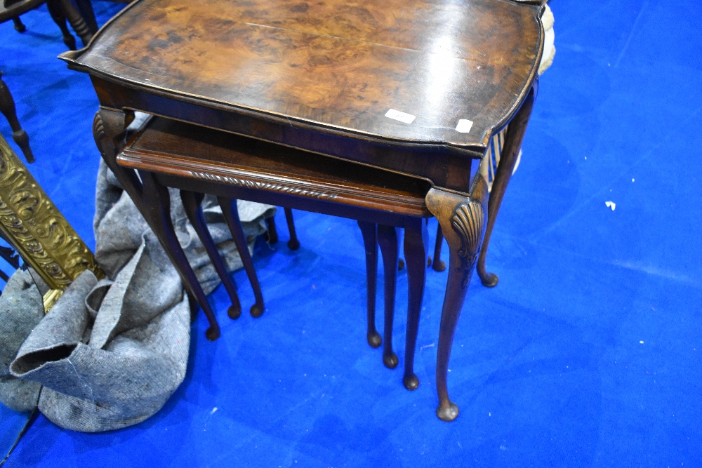 An early to mid 20th Century walnut occasional table and later nest of three period style tables