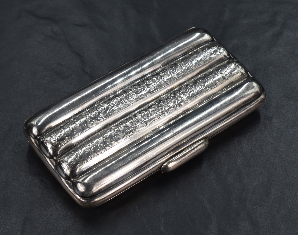 A Victorian silver cigar case, of lobed rectangular form to hold four cigars, having floral scroll