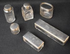 A collection of silver topped and mounted dressing table wares, including a Victorian cut glass