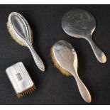 An Edwardian two-piece silver dressing table set, comprising a hairbrush and mirror having planished