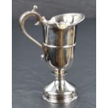 A Queen Elizabeth II silver cream jug, a reproduction of a 17th century ewer of heavy gauge with