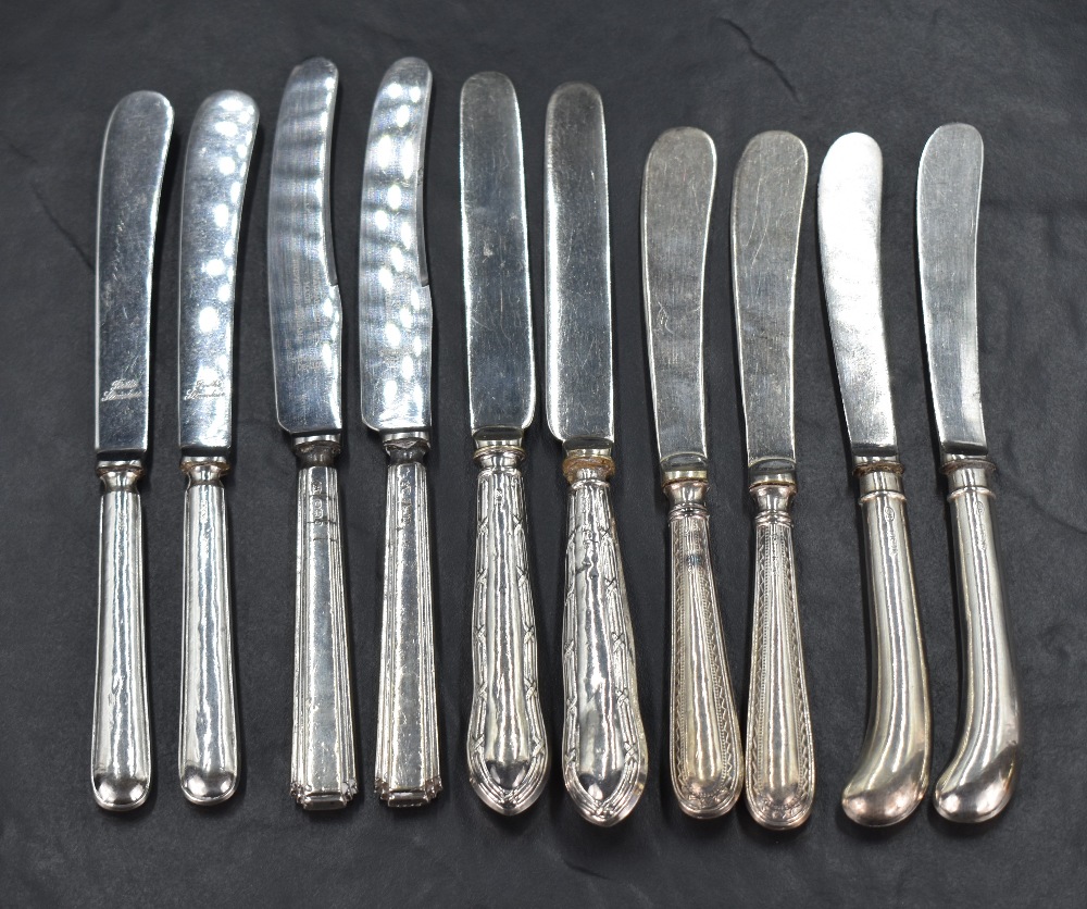 Five pairs of silver handled butter knives, of various form and design, marks for Sheffield 1910,