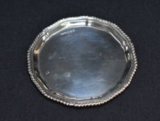 A George VI silver business or calling card tray, having a gadrooned rim and conforming lobbed petal