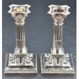 A pair of Victorian silver candlesticks of column design, having concave square detachable sconces