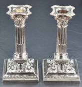 A pair of Victorian silver candlesticks of column design, having concave square detachable sconces