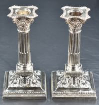 A pair of Victorian silver candlesticks of column design, having concave square detachable sconces