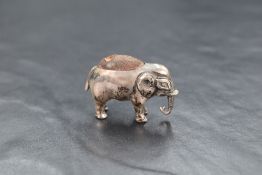 An Edwardian silver novelty pin cushion modelled as an elephant having dark fabric to the back,