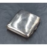 A Victorian silver cigarette case of curved square form, having a rubbed engraving to one side and