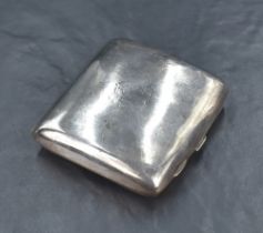 A Victorian silver cigarette case of curved square form, having a rubbed engraving to one side and