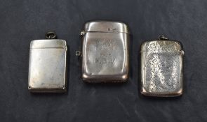 Three Edwardian vesta cases, one having FC from H.B.V engraved to front, another having floral motif