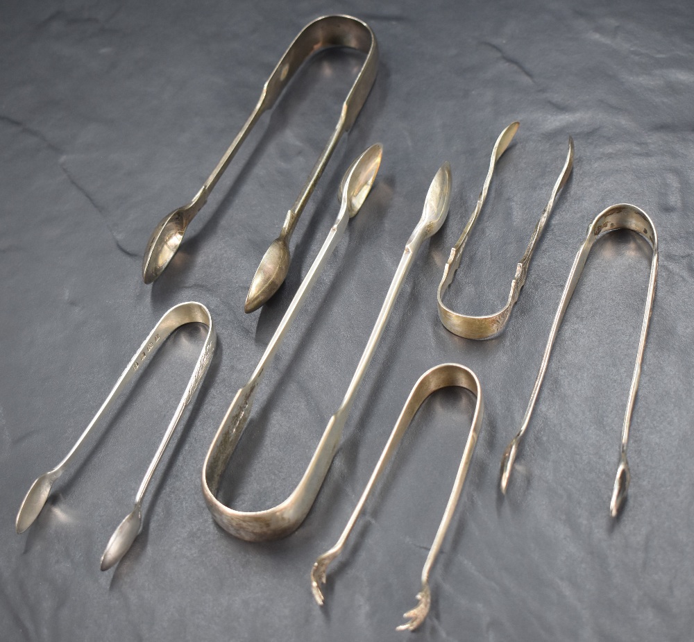 A group of six silver sugar tongs of various sizes, including a pair having decoratively engraved - Image 2 of 2