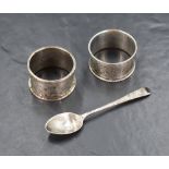 A Victorian silver napkin ring having decorative floral engraving and a vacant shield cartouche,