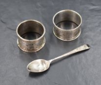 A Victorian silver napkin ring having decorative floral engraving and a vacant shield cartouche,