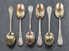 A cased set of six George V silver teaspoons, having beaded trim and scroll decoration, marks for