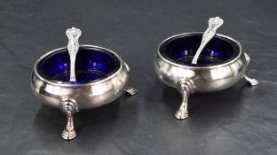 A pair of Victorian silver salts, of circular form with Bristol blue glass liners and stepped
