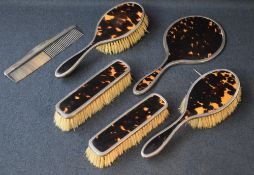 A George V silver and imitation tortoise shell dressing table set, comprising two hair brushes,