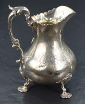 A Victorian silver cream jug of bluster form, having a conforming Chippendale style rim