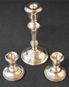 A pair of Elizabeth II silver squat candlesticks, the sconces of circular form raised on weighted
