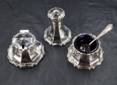 An early 20th century silver three-piece condiment set, of spreading stylised petal design with