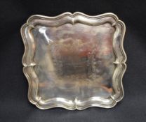An Edwardian silver tray, of square form with moulded and shaped Chippendale influenced rim