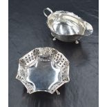 An Edwardian silver stout gravy boat, having a slightly flared shaped rim with open scrolled