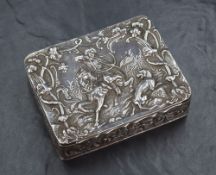 A late Victorian silver box of hinged rectangular form, the cover embossed with an Eastern hunting